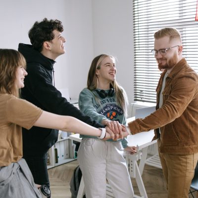 Group of young adults working as a team in a modern office setting.